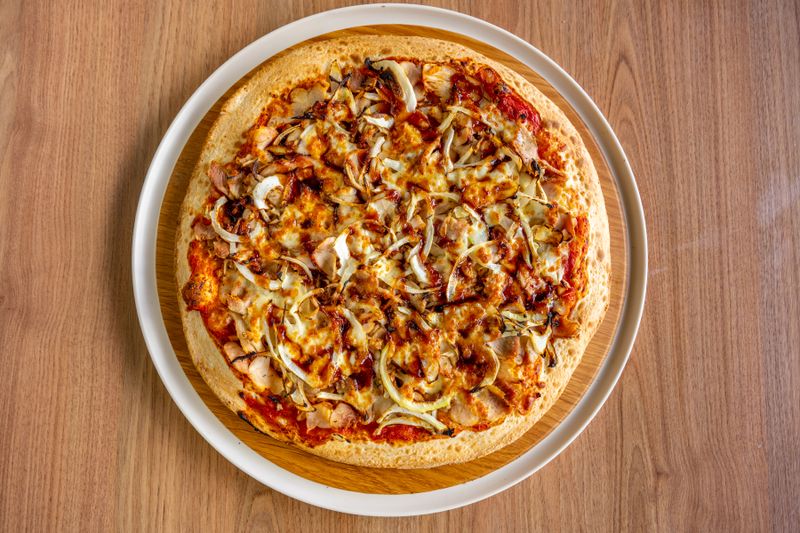 Spicy BBQ Chicken pizza with smoky BBQ sauce and jalapeños